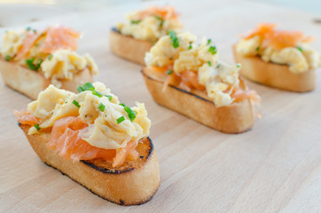 Toast with smoked salmon with scrambled eggs