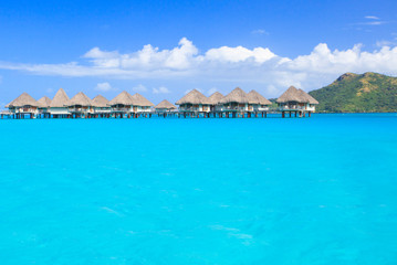 Overwater villas in blue tropical lagoon, Bora Bora, French Polynesia, South Pacific 