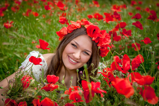 beautiful  woman sitting in the poppy flower