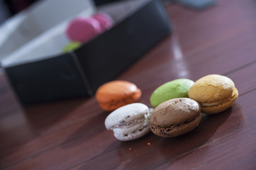 French colorful macarons on a wooden floor, morning snack