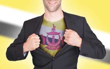 Businessman opening suit to reveal shirt with flag