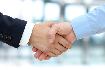 Close-up image of a firm handshake  between two colleagues