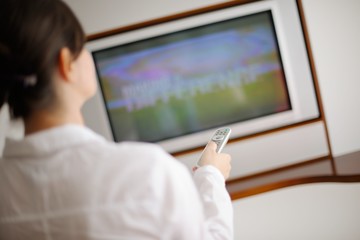 Fototapeta na wymiar young woman watching tv at home
