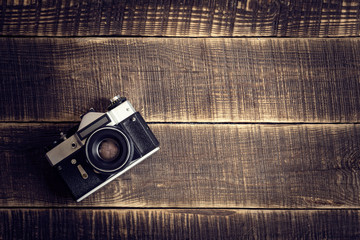 Old camera on wooden table