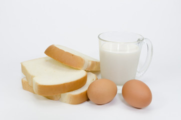 Slices of bread isolated  eggs and milk on white background
