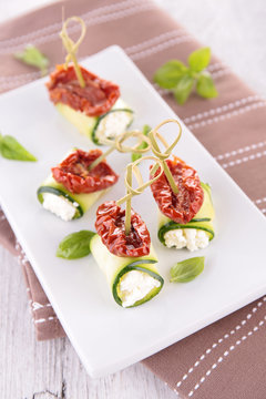 zucchini roll with cream and dried tomato