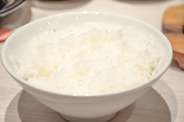 White steamed rice in white round bowl