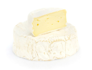 Round camembert cheese with a piece on white background