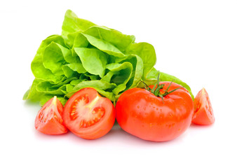 Fresh tomatoes and green salad isolated on white background