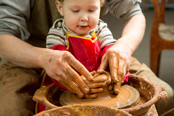 hands of a potter, creating an earthen jar