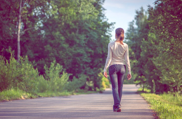 background girl standing turned her back on urban asphalt road