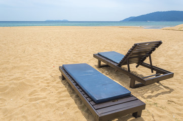 Wooden lounge with clean sand at tropical island
