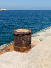 Naklejka premium Rusty old iron column on the coast of Valletta, Malta