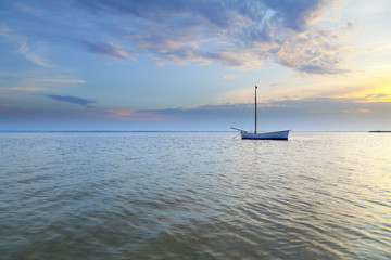 Lonely boat moored in the bay - obrazy, fototapety, plakaty