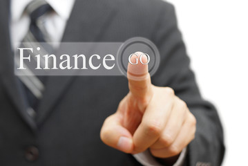 Businessman pressing  finance  on virtual button
