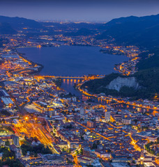 Night view of the city Lecco and Lake Garlate - obrazy, fototapety, plakaty