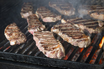 beef steak cooking on an open flame grill