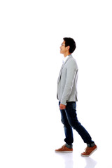 Full body side view of a fashion man walking forward