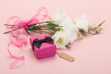 gift and flower on pink