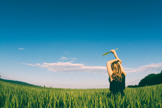 Blonde wman holding wheat. Freedom in the nature stock image.