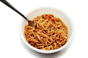 Eating Asian Noodles with Sesame Seeds with a Fork