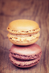 Two macaroons on retro vintage wooden background