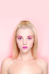 beautiful blond hair woman on a pink background