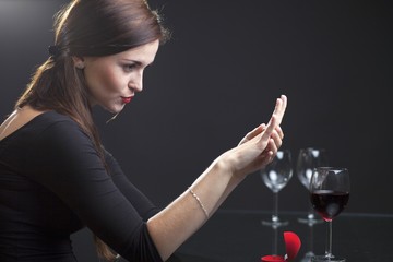 Woman with engagement ring in restaurant