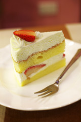 close up strawberry cheese cake in white dish