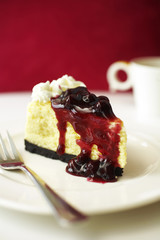 close up blue berry cheese cake in white dish