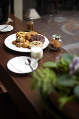 close up many cookies and milk on wooden table