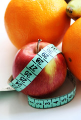 Fruits and measurement tape on the white background