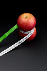 Apples with meter on dark background