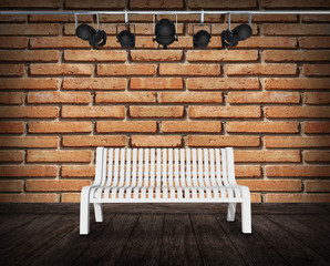 White chair against brick wall 