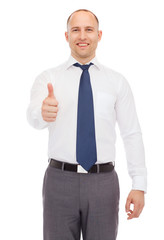 smiling businessman showing thumbs up