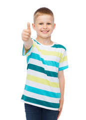 little boy in casual clothes showing thumbs up