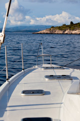 Fototapeta na wymiar The white yacht floats by the blue sea
