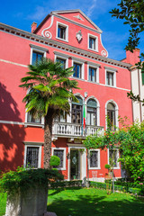 Naklejka premium Narrow canal among old colorful brick houses in Venice
