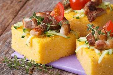 Polenta with meat, tomato and thyme on the table