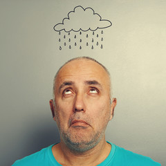 senior man with drawing storm cloud