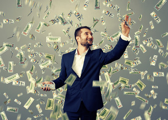 smiley businessman catching money