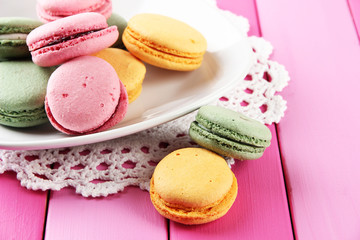 Gentle macaroons on plate on table close-up