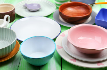 Different tableware on wooden background