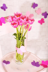 Composition with bouquet of tulips in vase,