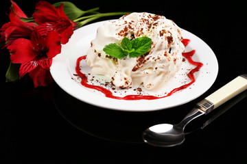 Tasty cake with cream, on black background © Africa Studio