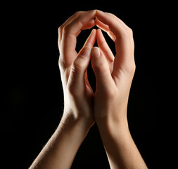 Human hands on black background