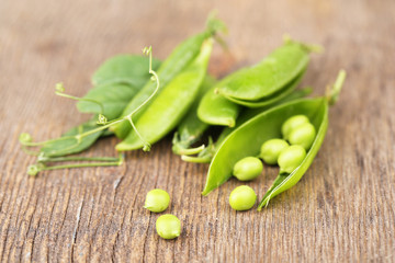Fresh green peas on wooden table