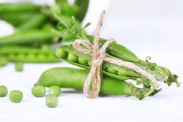 Fresh green peas on wooden table
