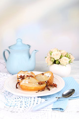 Baked pears with syrup on plate, on bright background