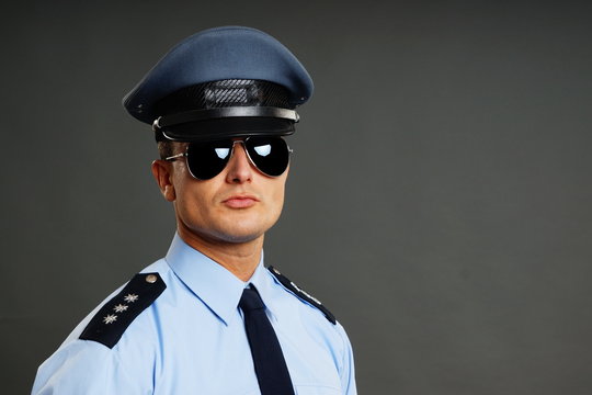 Portrait Of Policeman In Uniform In Sunglasses